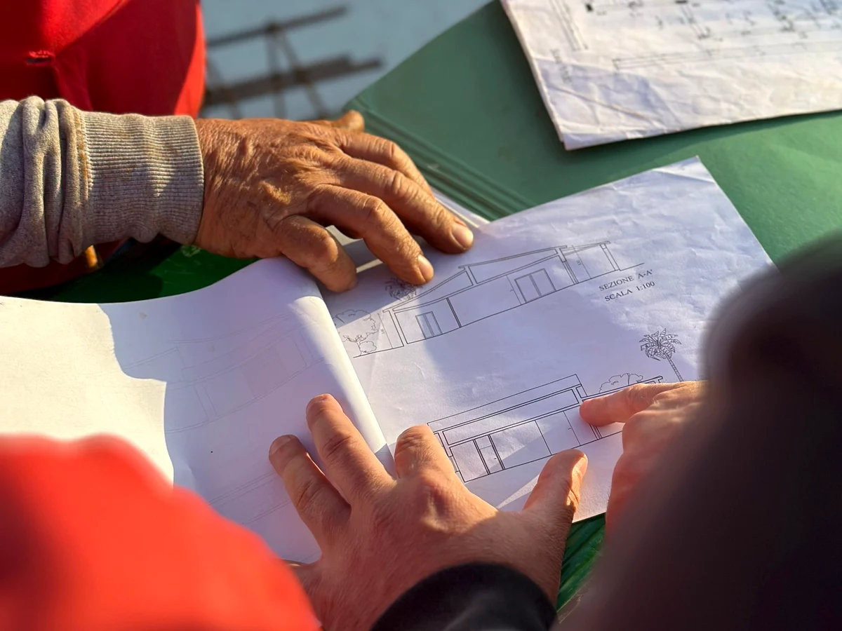 Architects and construction professionals reviewing permit drawings at the project site