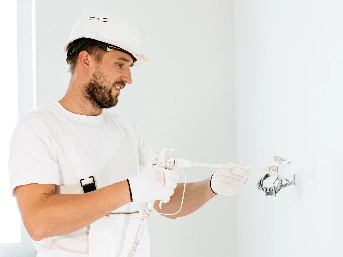 Licensed electrician installing approved electrical corrections during permit work