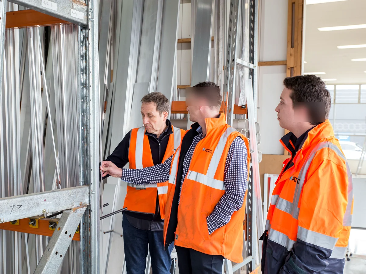 Construction professionals inspecting metal framing and building components