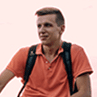 A man in orange with a backpack