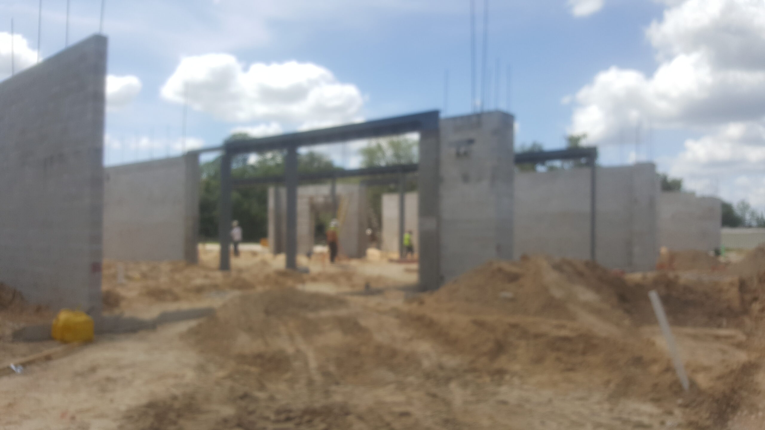 A blurry photo of a construction site where an entrance is being built
