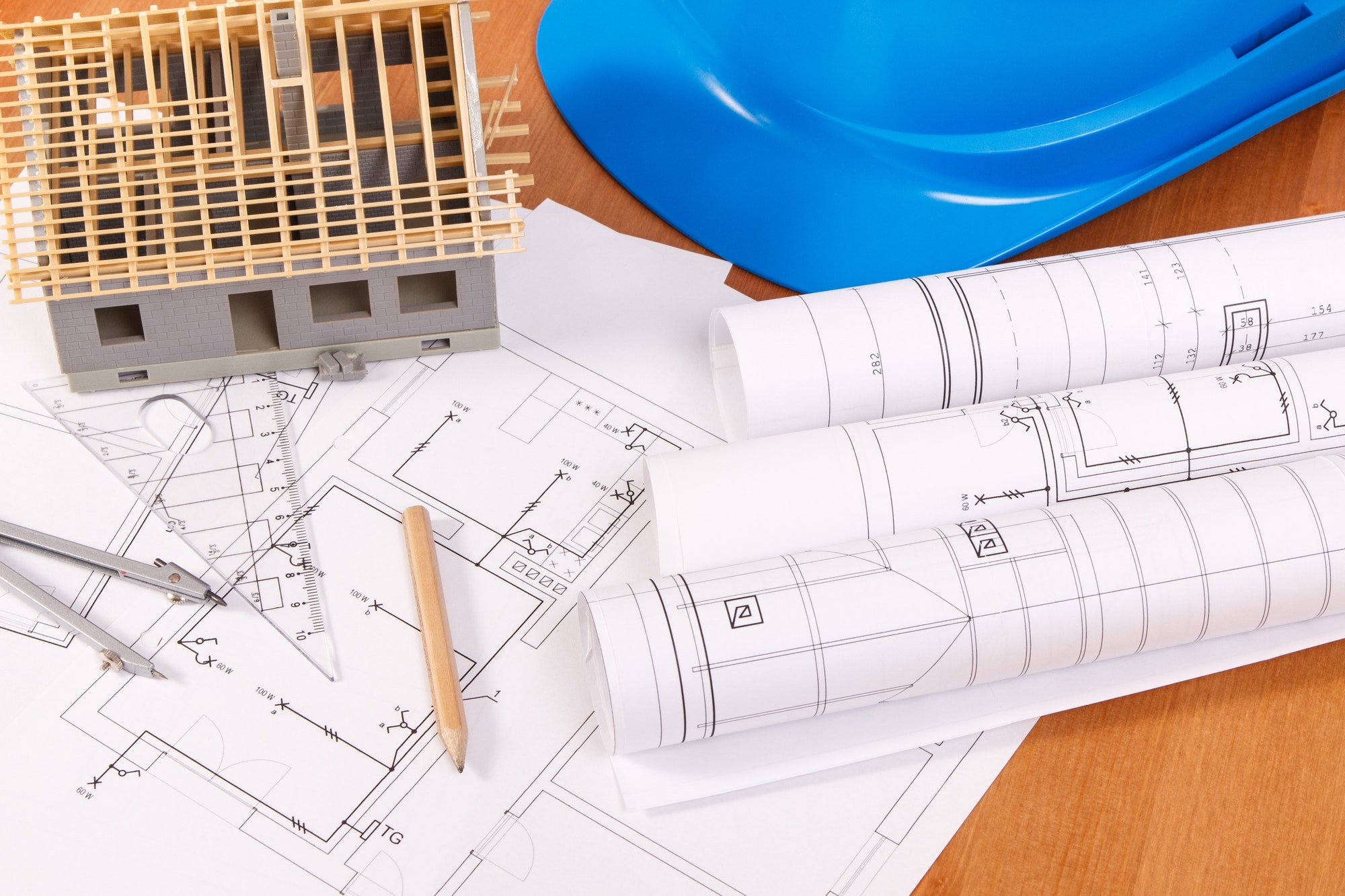 Electrical diagrams and a model of a house under construction