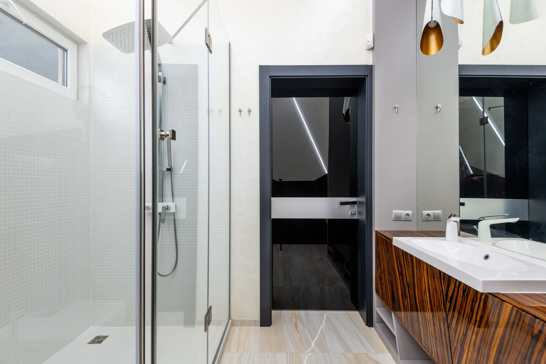 Renovated residential bathroom with walk-in shower and coordinated fixtures
