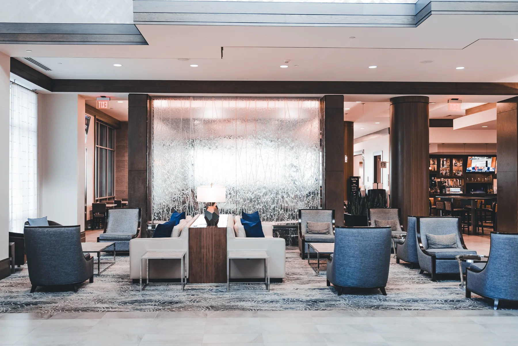 Hotel lobby seating with blue pillows and lamp