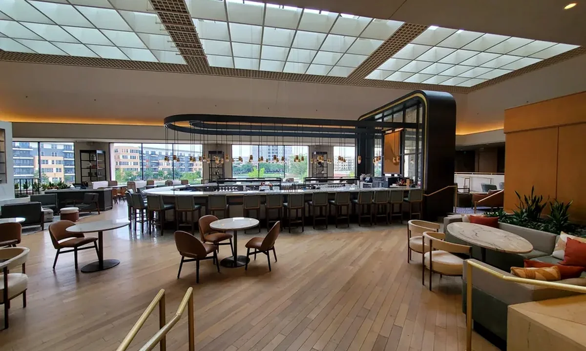 Bright atrium dining area with curved bar